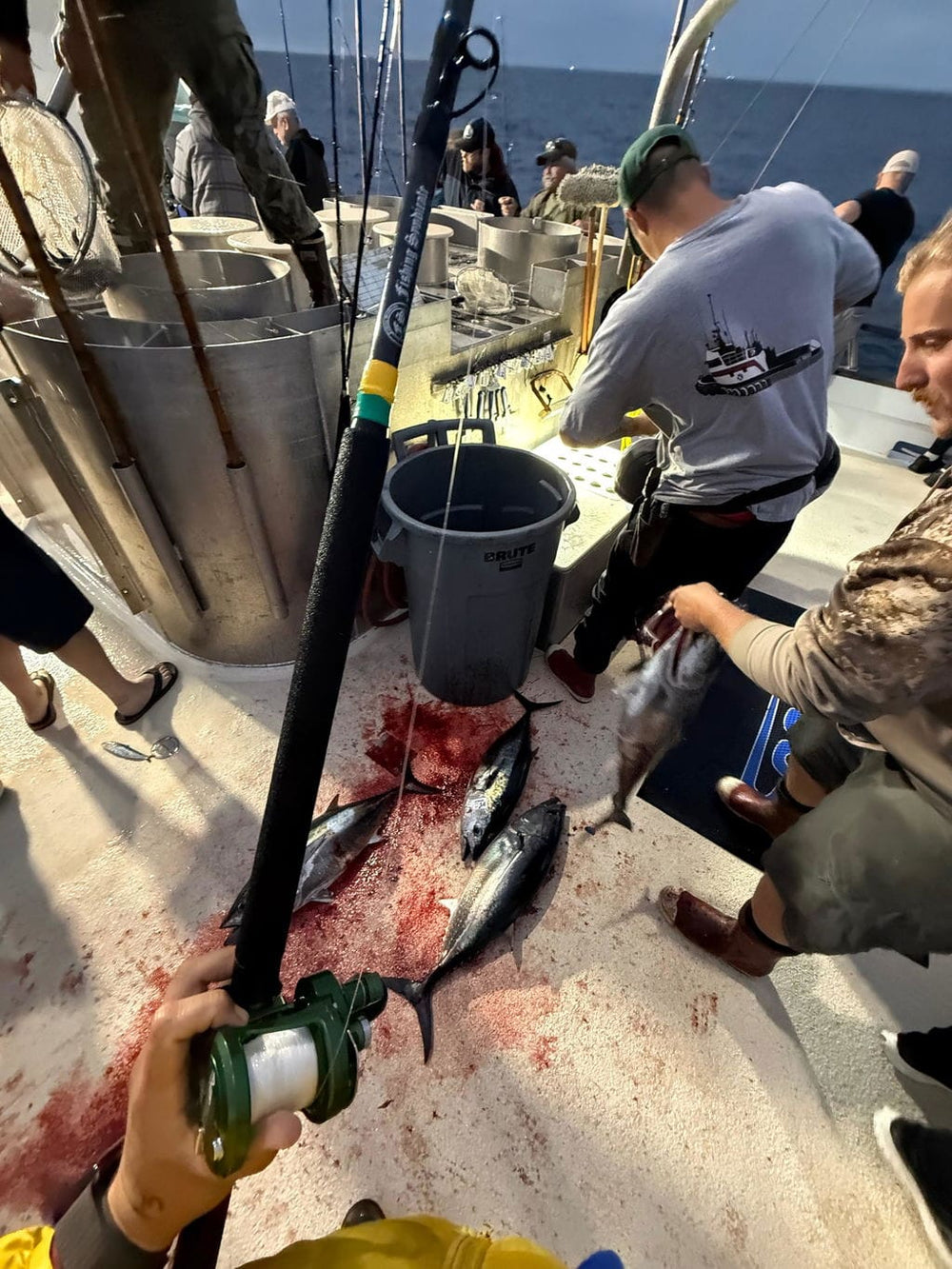 Hernan holding tuna caught while fishing Opsin leader